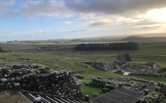 Housesteads Roman Fort featuring stairs on the left and center, stone ruins left of the stairs and towards the back of the photo.