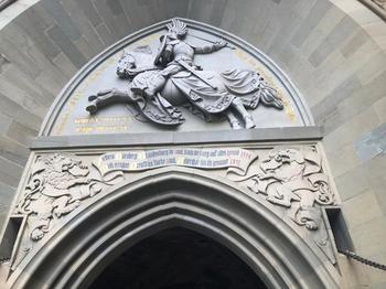 Door entrance with knight on a horse above the entryway