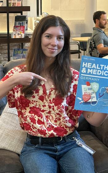 Stripes Writer Katie holding up our Germany Health and Medical Guide at the Spouse Hub