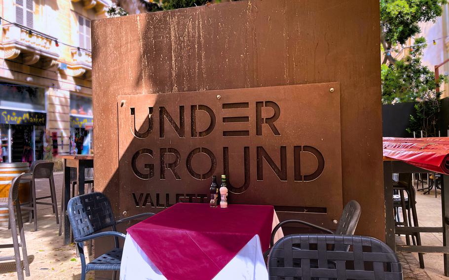 The “Under Ground Valletta” sign beside an outdoor Caffe Mauro table