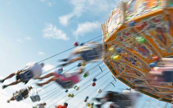 People enjoying the ride in a classic Chair-O-Planes at the fair