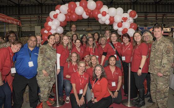 Photo Of Group of volunteers under a balloon arch