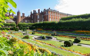 Georgian and Tudor Facades of Hampton Court Palace with the foreground showing the colorful sunken gardens