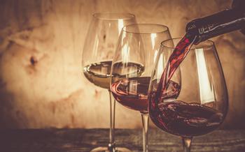 Three different types of wine in seperate glasses against a wood background