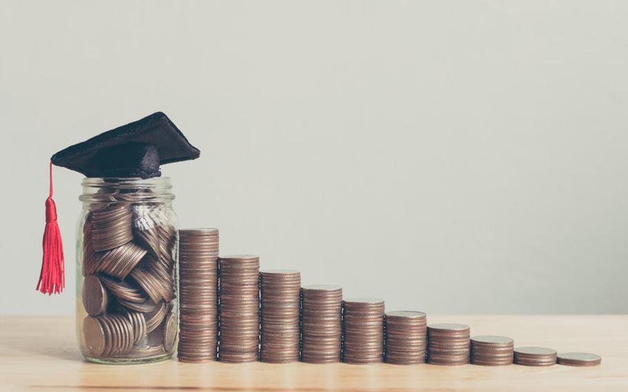 Money and coins in jar with graduation cap