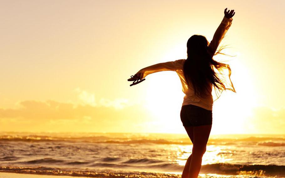 Women on beach at sunrise