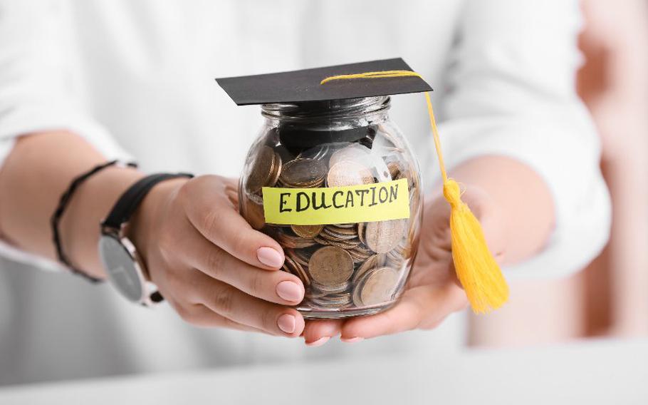 Jar with coins inside labeled "education" with a graduation cap on top
