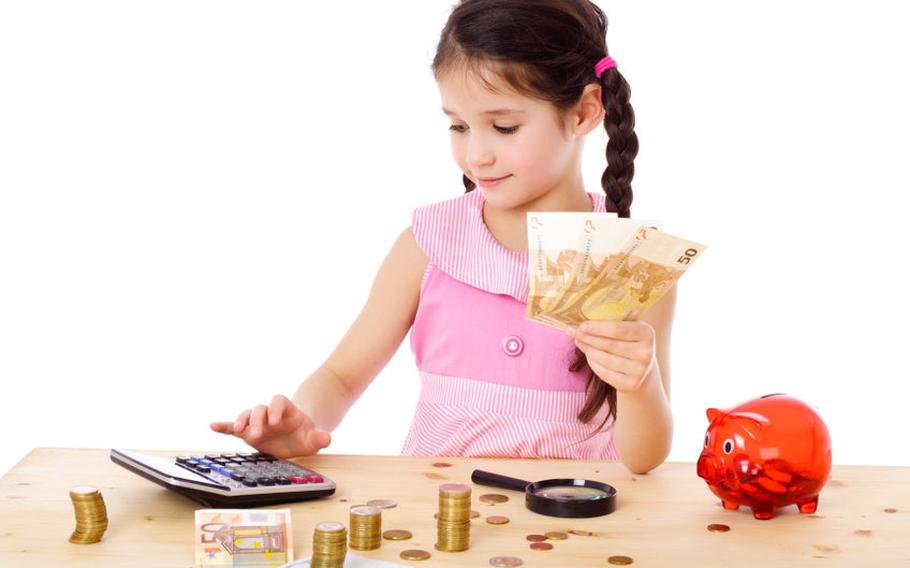Girl counting money at table