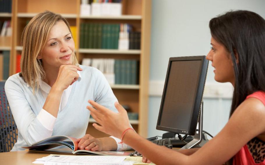 Female student talking with female tutor or counselor