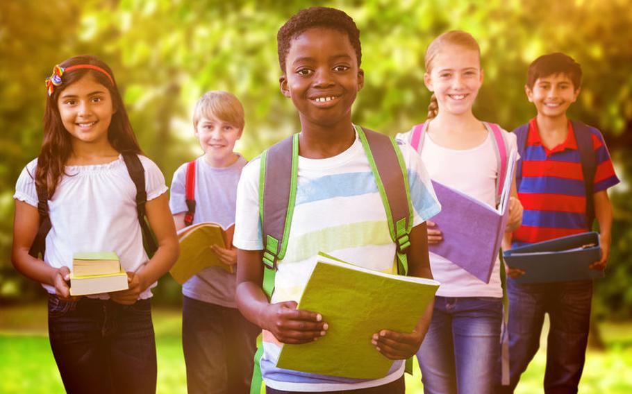 Kids holding notebooks and wearing backpacks