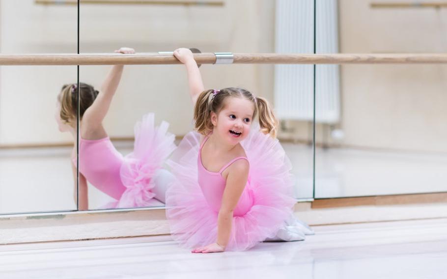 Child in pink ballerina tutu in a dance studio