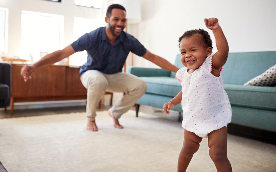 Baby dancing with parent