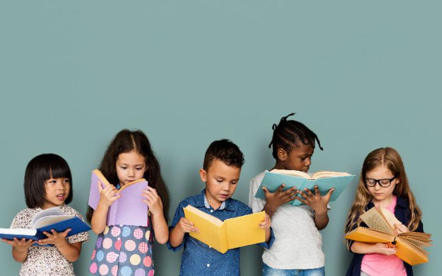 Group of kids reading books