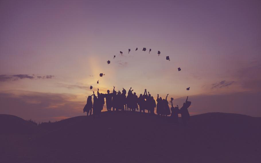 Group of people tossing graduation caps