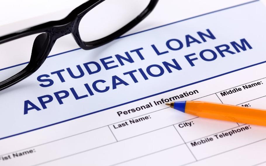 Student loan application form with pen and glasses