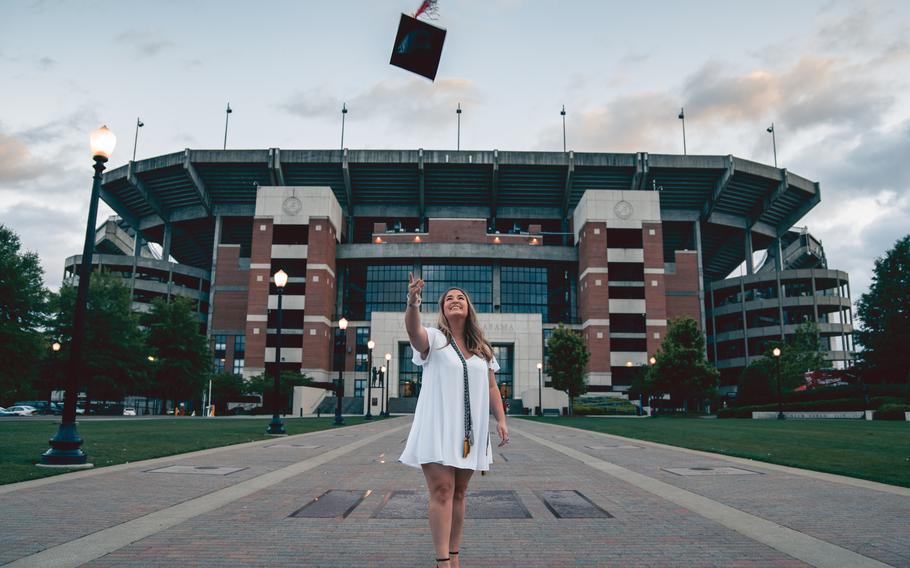 Student tossing up graduation cap