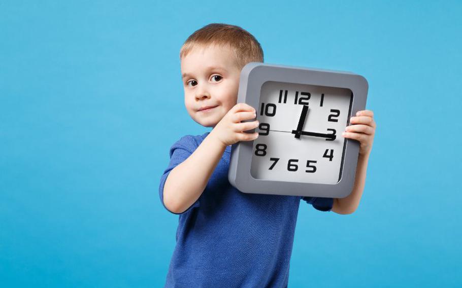 Child holding a clock