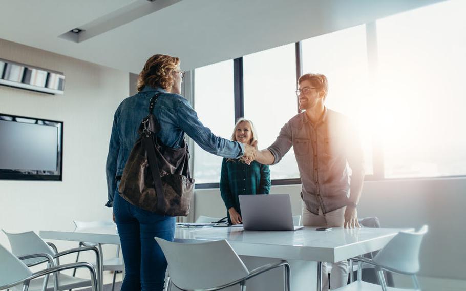 People shaking hands at the end of a meeting