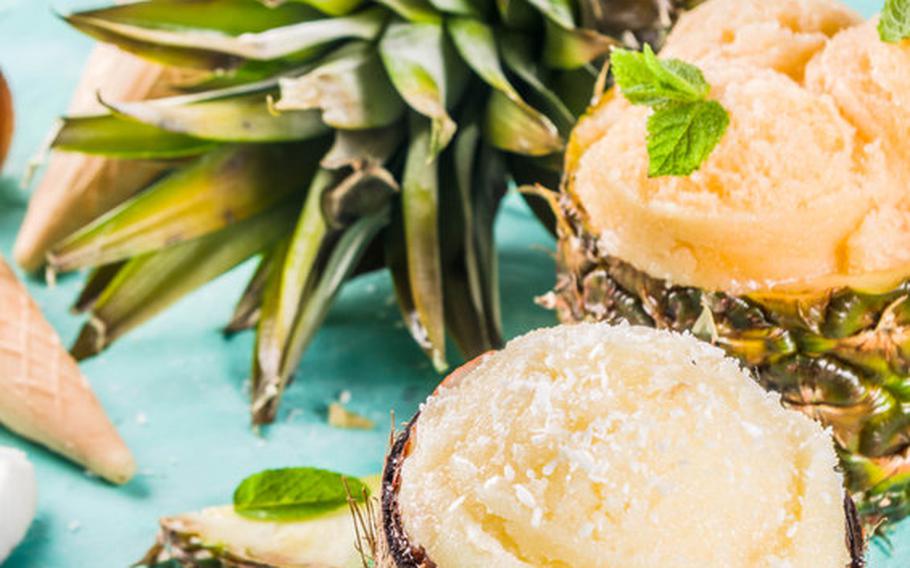 Sorbet in coconut shell with pineapple in background