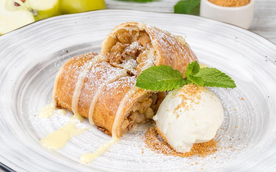 Strudel with white ice cream on round plate