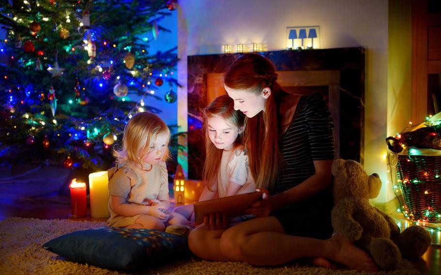 Family huddled around a screen