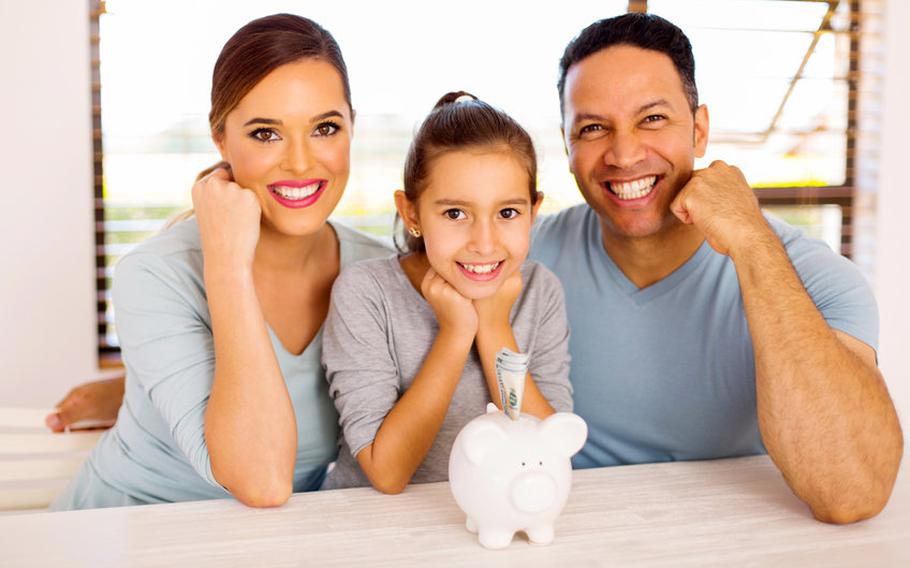 Family of three with piggy bank