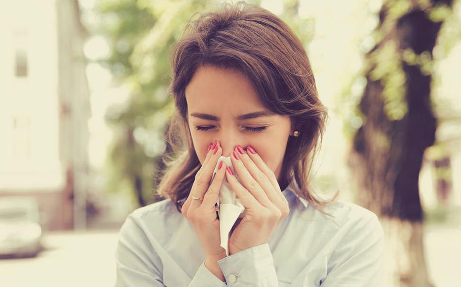 Woman blowing nose