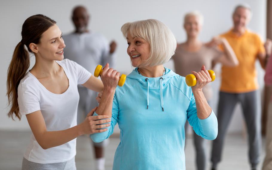 Woman leading senior citizens' fitness class