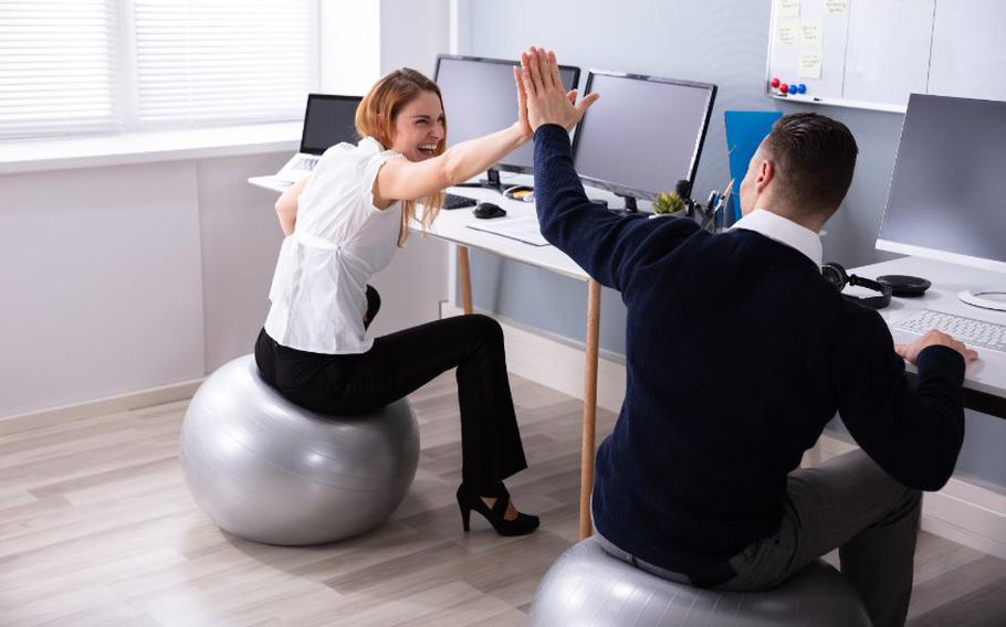 Business people sitting on fitness balls