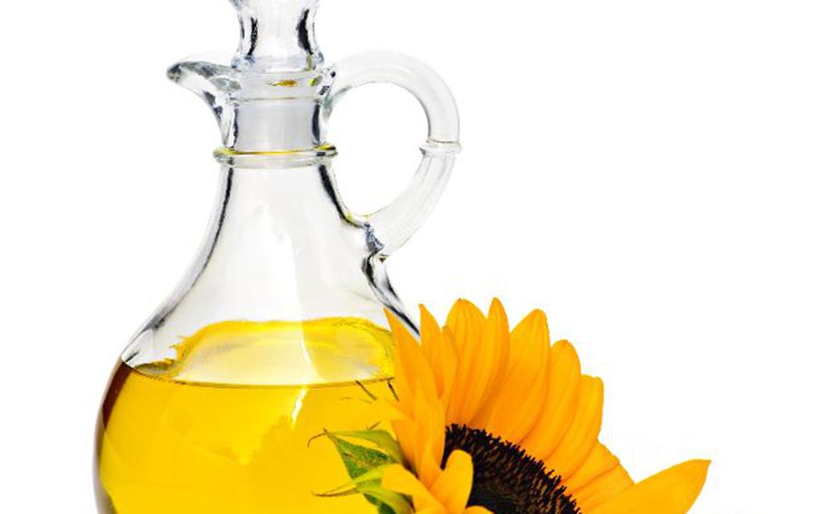 Sunflower oil bottle and sunflower