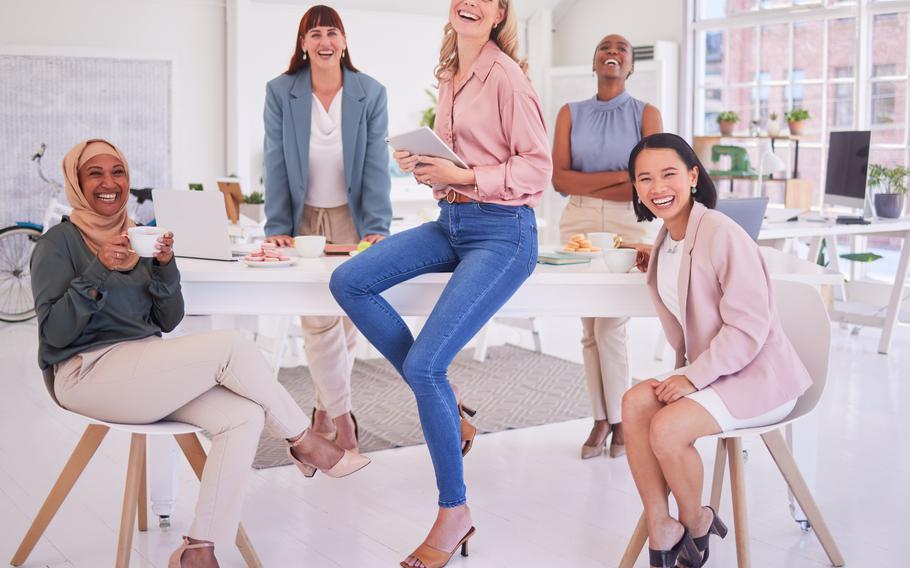 Group of women sitting around a table in business attire