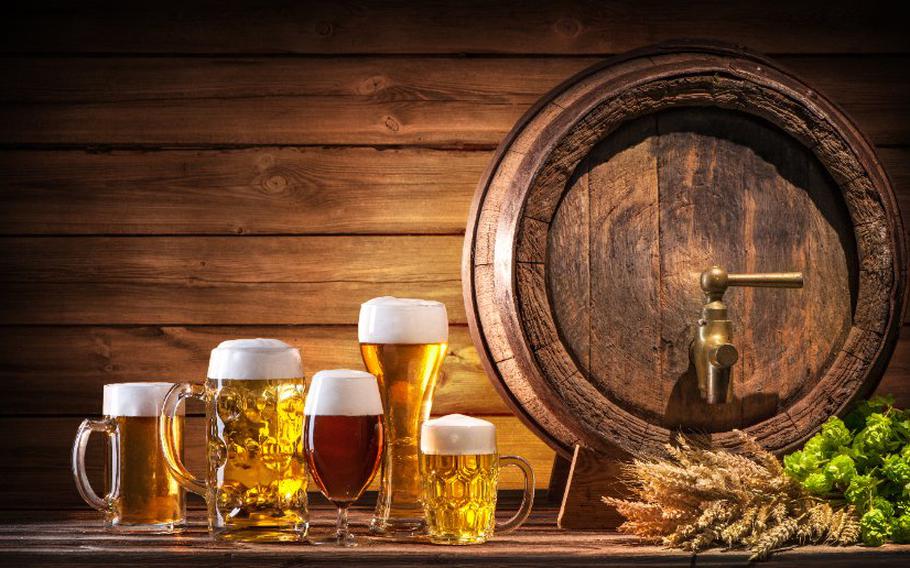 Oktoberfest beer barrel and beer glasses with wheat and hops on wooden table | Copyright alexraths