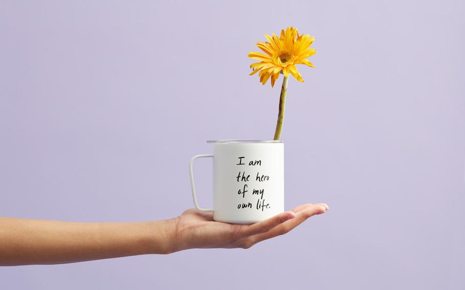 Hand holding a potted plant | Photo by Thought Catalog via Unsplash