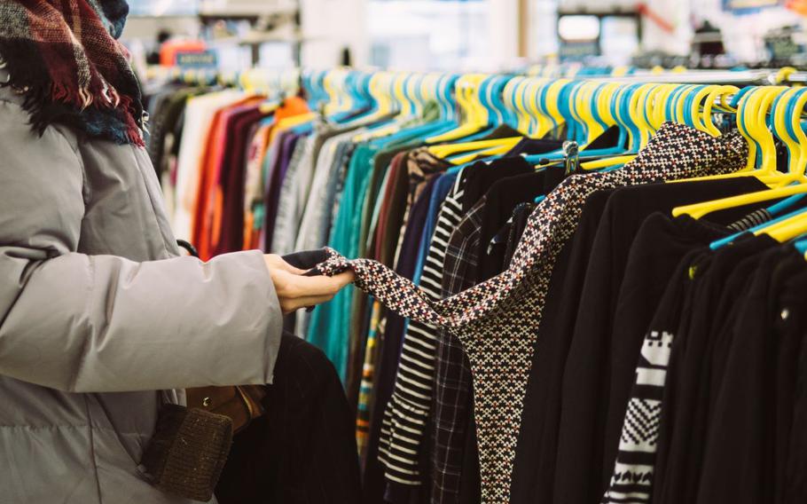 Person looking through clothing rack