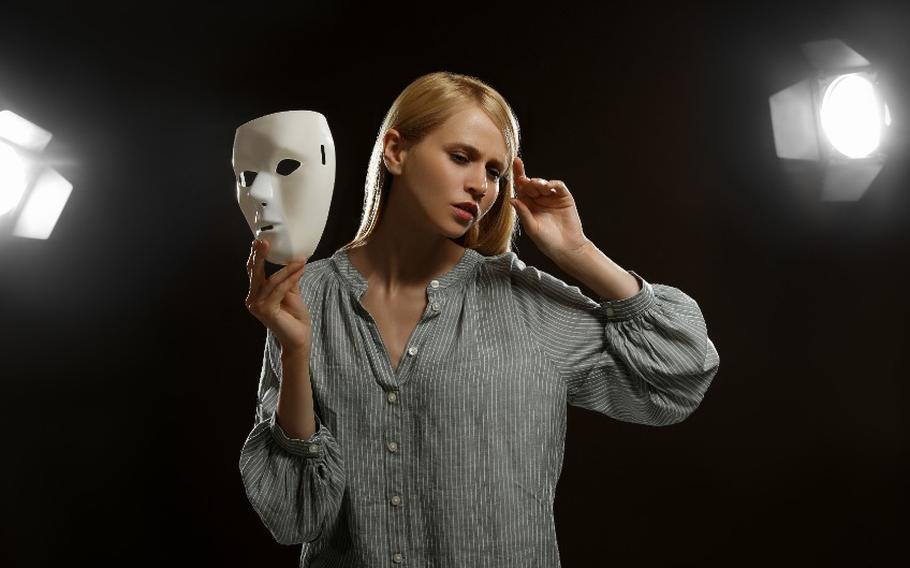 Professional actress rehearsing with mask on stage
