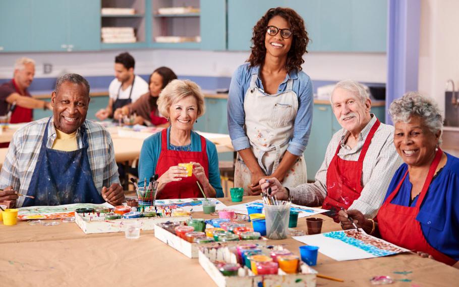 Female art instructor with adult students