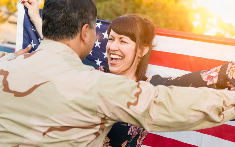 Military member and spouse smiling at each other