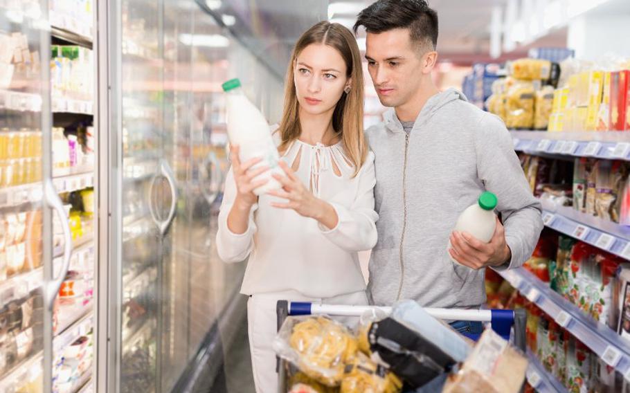 Man and woman shopping for dairy items