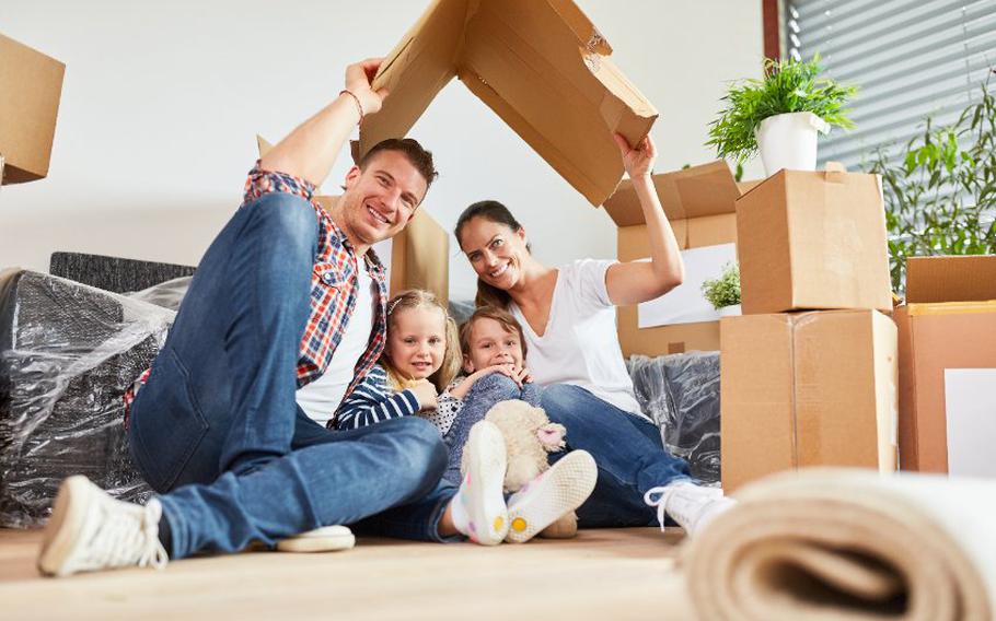 Parents and children surrounded by packing boxes