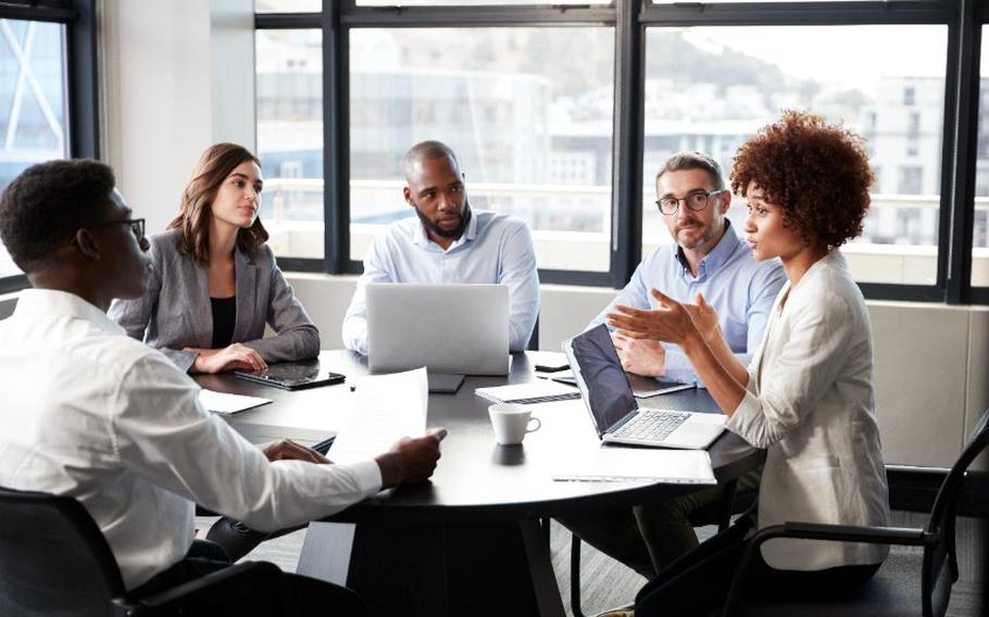 Businesswoman addressing colleagues at a corporate business meeting