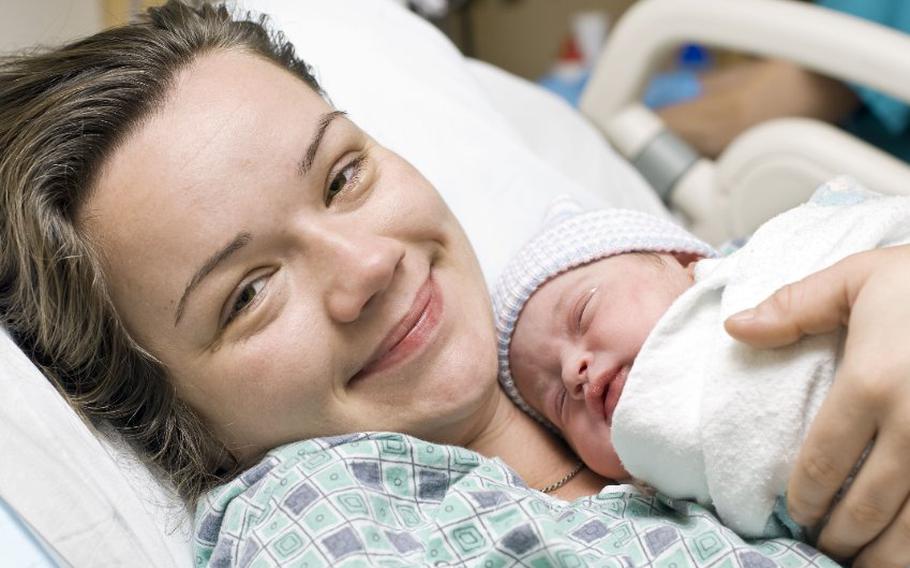 Person holding newborn child