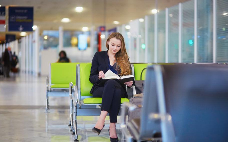 Young adult with book at airport