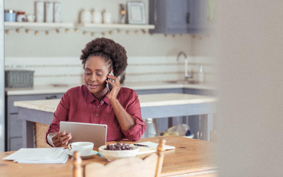 Woman using a tablet and talking on the phone