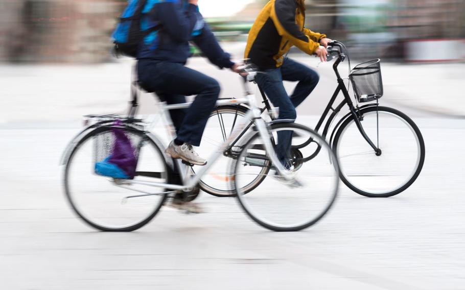 Two young men on bicycles in blurred motion