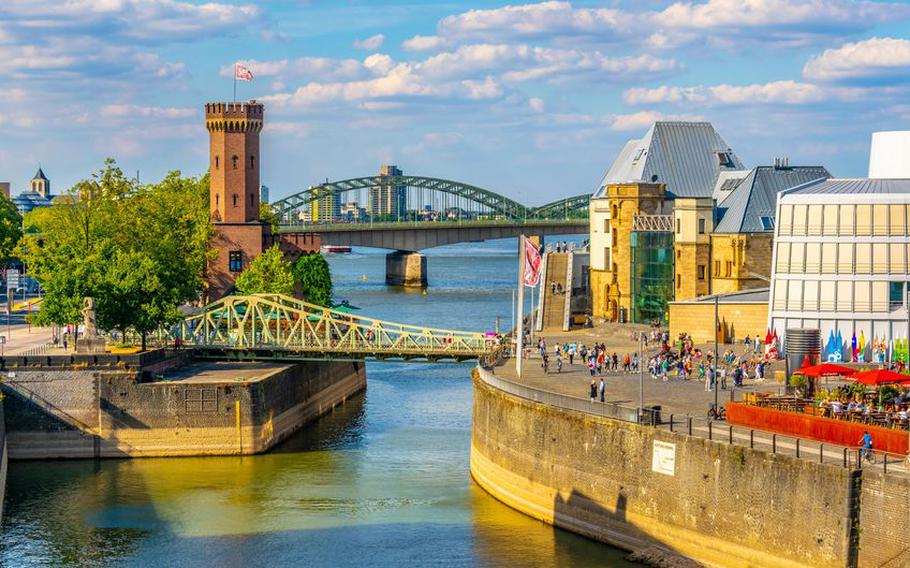 People are passing between Malakoffturm tower and Chocolate museum in Cologne, Germany | Photo by dudlajzov via 123RF.