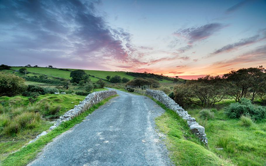 Road with a rising sun in background