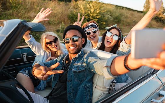 Group of people taking selfie in car