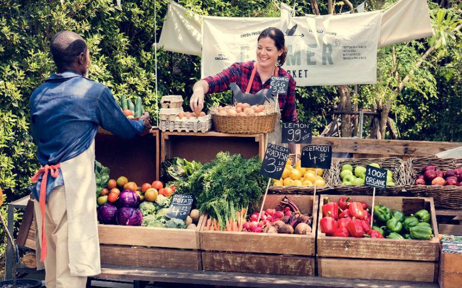 Woman selling vegetables at farmers' market