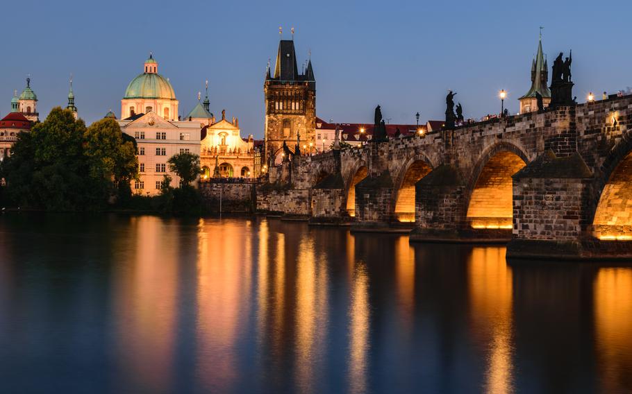 Charles Bridge after sunset. | Photo by Dmitry Goykolov via Unsplash.