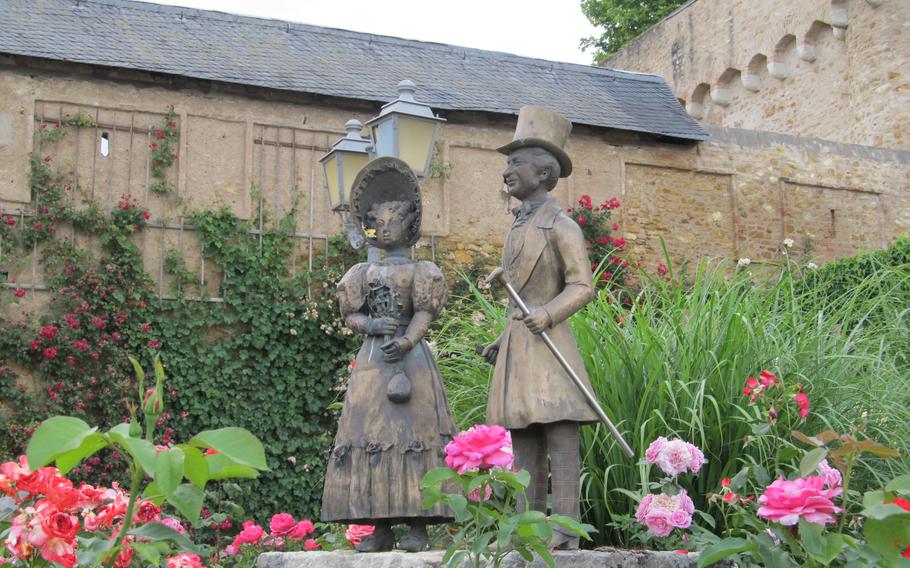 Statue of man and woman in garden